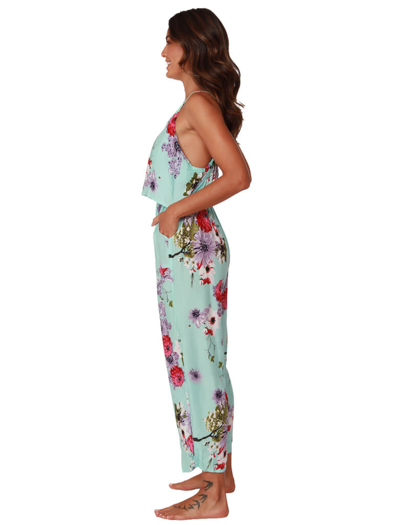 A bright floral print flounced top jumpsuit, side view