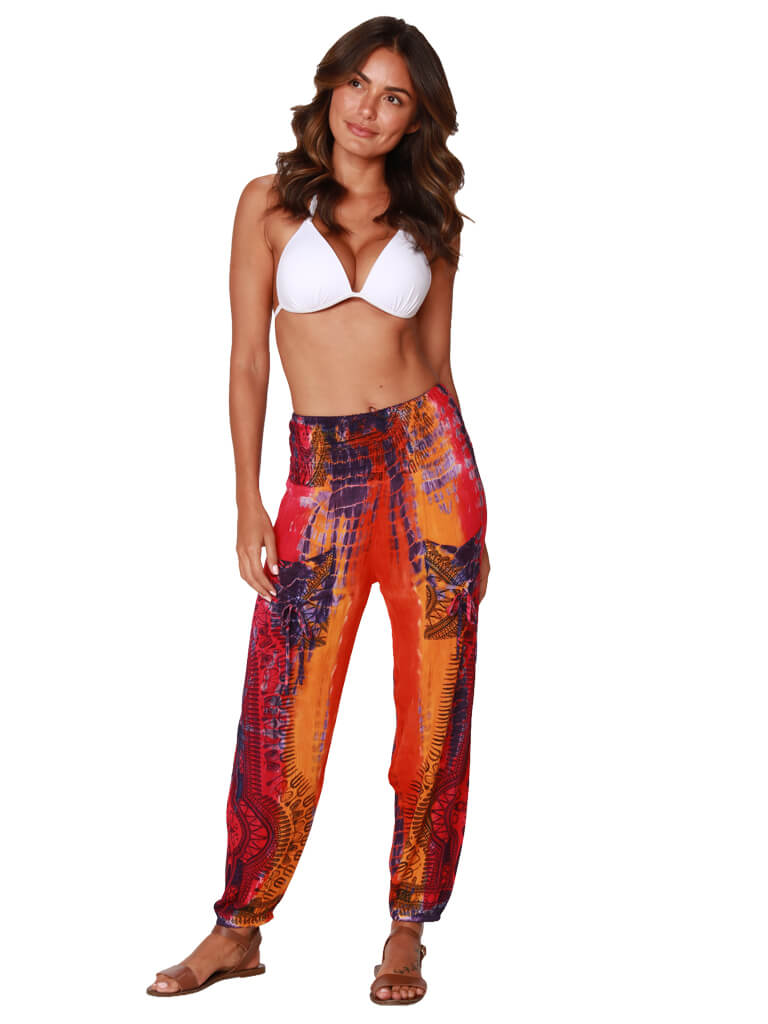 A brilliantly tie-dyed and printed daihiki smocked top harem pant, front view