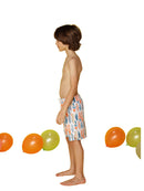 Boy's board trunks patterned in surfboards, side view