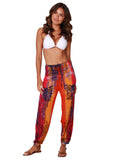 A brilliantly tie-dyed and printed daihiki smocked top harem pant, front view