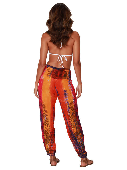 A brilliantly tie-dyed and printed dashiki smocked top harem pant, back view