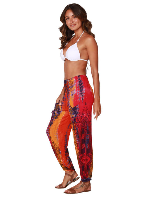 A brilliantly orange and pink tie-dyed and printed dashiki smocked top harem pant, side view
