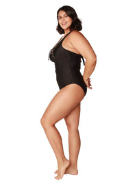 Side view of black lace-up one piece bathing suit